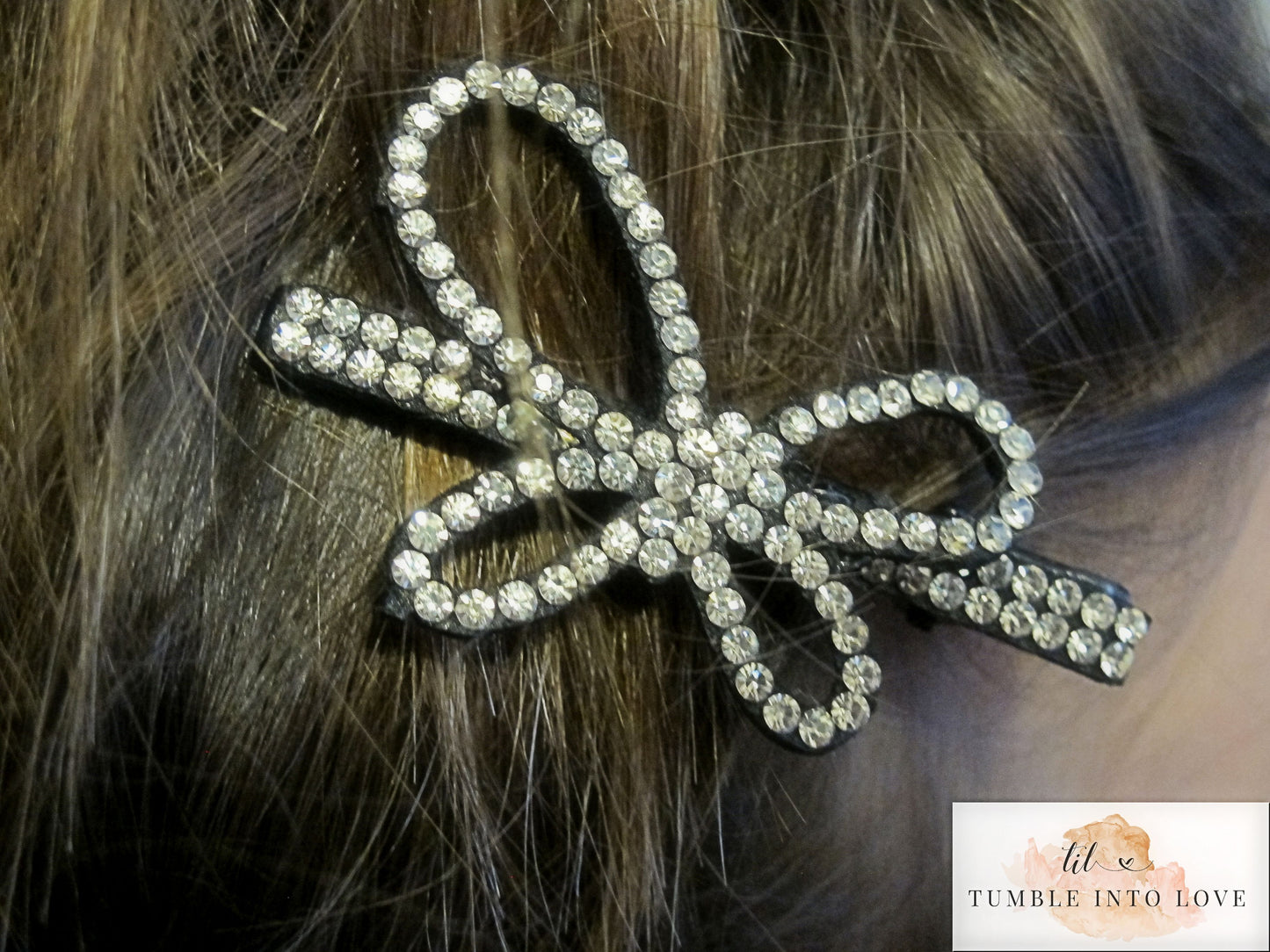 Image of butterfly silver rhinestone clip in brown hais