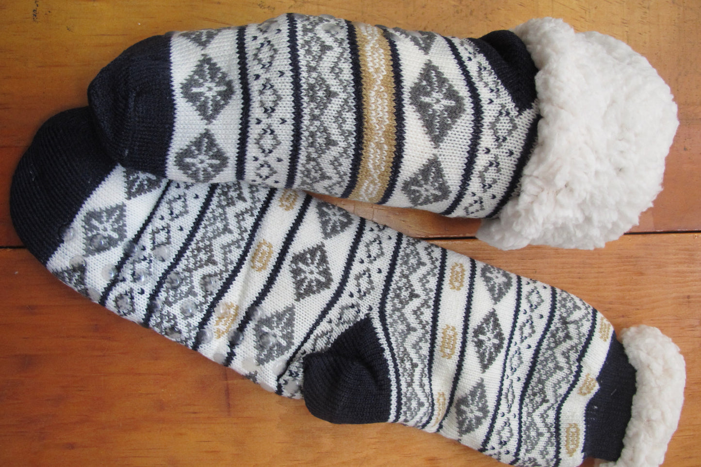 Sherpa-Lined Cabin Socks.  Image shows black and brown color.  Snowflake/faireisle desgin
