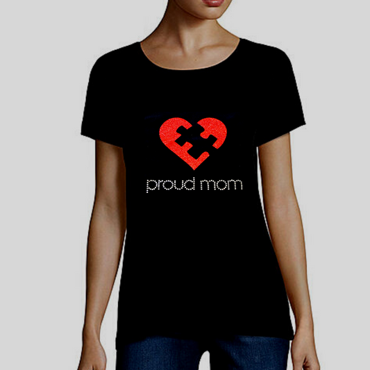 Embrace Difference Tees -Proud Mom - Tumble into Love.  Black tee shirt with a red glitter heart with a black puzzle piece in the center. Proud mom is spelled out underneath, in silver rhinestones.