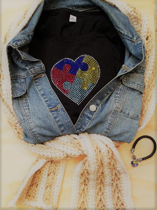 Embrace Difference Tees -Small Heart - Tumble into Love Black short sleeved tee shirt with small heart.  Heart has 4 colors blue, yellow, red and green. puzzle pieces.  Heart is outlined in sliver rhinestones.