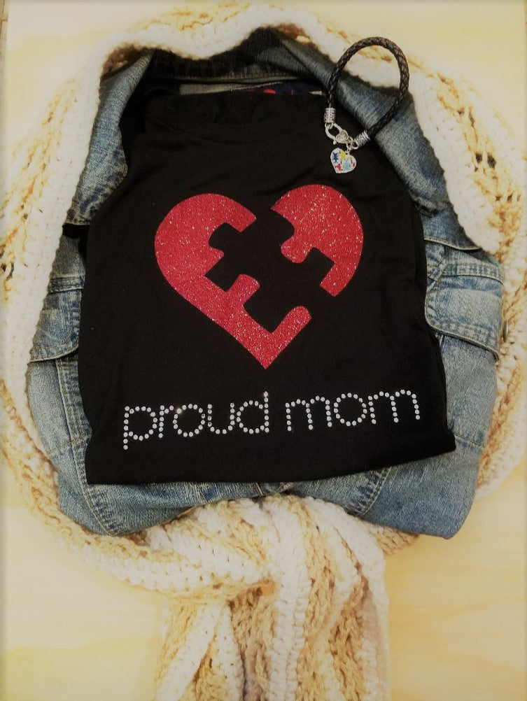 Embrace Difference Tees -Proud Mom - Tumble into LoveA red glitter heart with a black puzzle piece in the center. Proud mom is spelled out underneath, in silver rhinestones.